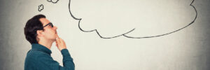 Businessman contemplating- a thought bubble is drawn to signify this.